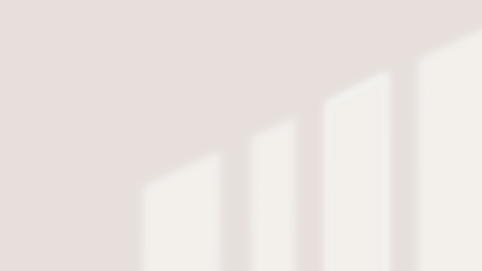 Minimal off-White wall with soft shadows representing permissive minimalism and a quiet, gentle way of living