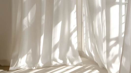 Soft natural light filtering through sheer curtains, creating gentle shadows and a calm, breathable atmosphere.